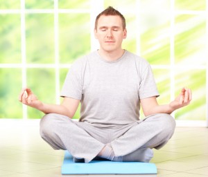 Man doing yoga exercise on mat